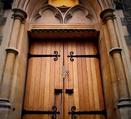 Image showing wooden parliament in london old church door and marble antique  