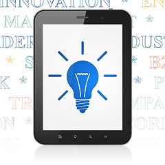 Image showing Finance concept: Tablet Computer with Light Bulb on display