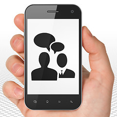 Image showing Business concept: Hand Holding Smartphone with Business Meeting on display