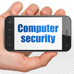 Image showing Security concept: Hand Holding Smartphone with Computer Security on display