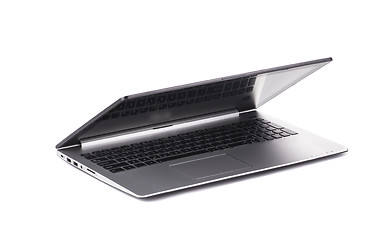 Image showing Silver laptop half closed on white background