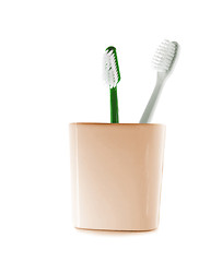 Image showing Two toothbrushes in glass