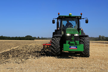 Image showing John Deere 8370R Tractor on Field with Headlights on 