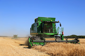 Image showing Two John Deere Combines Harvest Barley