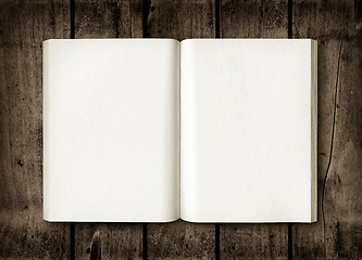 Image showing Open book on a dark wood table