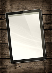 Image showing Digital tablet PC on a dark wood table