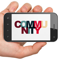 Image showing Social network concept: Hand Holding Smartphone with Community on  display