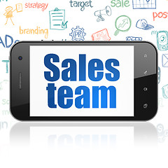 Image showing Marketing concept: Smartphone with Sales Team on display