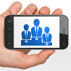 Image showing Law concept: Hand Holding Smartphone with Business Team on display