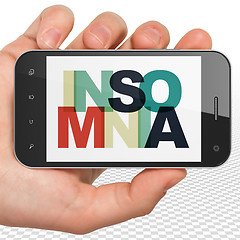 Image showing Healthcare concept: Hand Holding Smartphone with Insomnia on  display