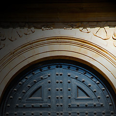 Image showing handle in london antique brown door  rusty  brass nail and light