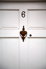 Image showing handle in london antique brown door    nail and light