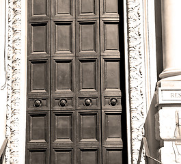 Image showing handle in london antique brown door  rusty  brass nail and light