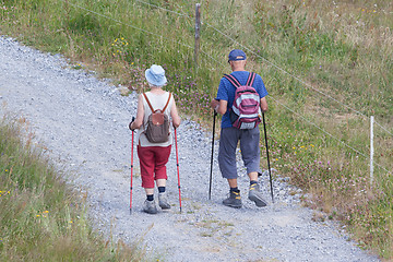 Image showing Senior tourist couple hiking at the beautiful mountains