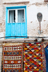 Image showing blue window in  africa and brown wall red carpet