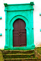 Image showing old door in morocco  and wall ornate green