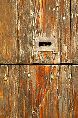 Image showing  red abstract  house door    in italy         closed nail rusty