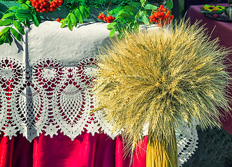 Image showing A sheaf of wheat on a background of lace fabric.