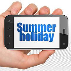 Image showing Travel concept: Hand Holding Smartphone with Summer Holiday on display