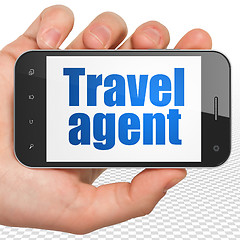 Image showing Travel concept: Hand Holding Smartphone with Travel Agent on display