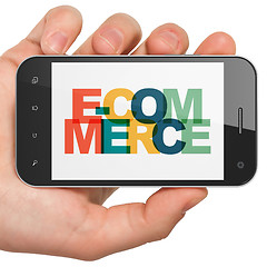Image showing Finance concept: Hand Holding Smartphone with E-commerce on  display
