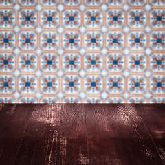 Image showing Wood table top and blur vintage ceramic tile pattern wall