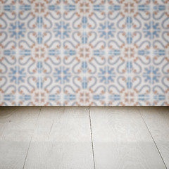 Image showing Wood table top and blur vintage ceramic tile pattern wall