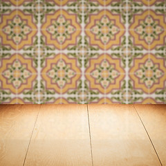 Image showing Wood table top and blur vintage ceramic tile pattern wall