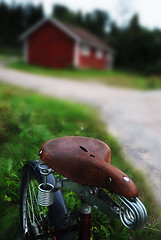 Image showing vintage bicycle with the seat at a rural road