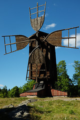 Image showing ancient wooden windmill against the blue sky