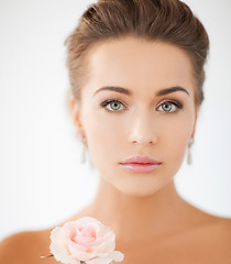 Image showing young woman with rose flower