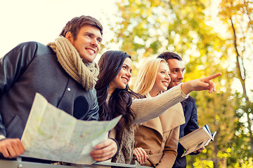 Image showing group of friends with map outdoors