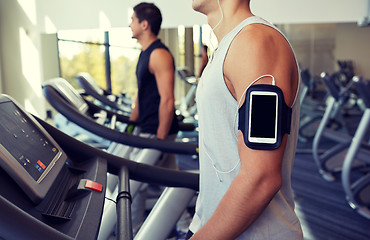 Image showing close up of man with smartphone in gym