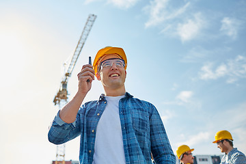 Image showing builder in hardhat with walkie talkie