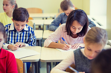 Image showing group of school kids writing test in classroom