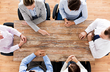 Image showing close up of business team sitting at table