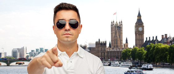 Image showing man in sunglasses pointing finger on you