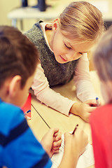 Image showing group of students talking and writing at school