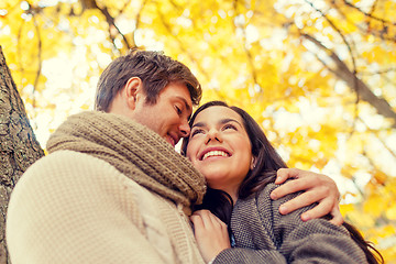 Image showing smiling couple hugging in autumn park