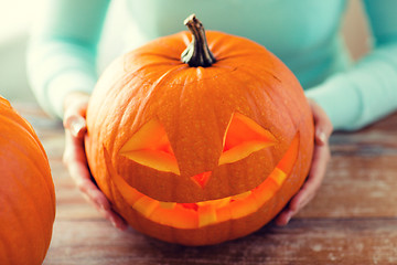 Image showing close up of woman with pumpkins at home