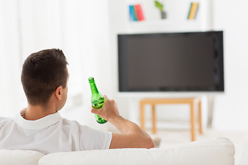 Image showing man watching tv and drinking beer at home