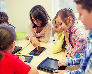 Image showing group of school kids with tablet pc in classroom