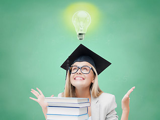 Image showing happy student girl in bachelor cap with books