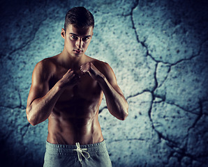 Image showing young man in fighting or boxing position