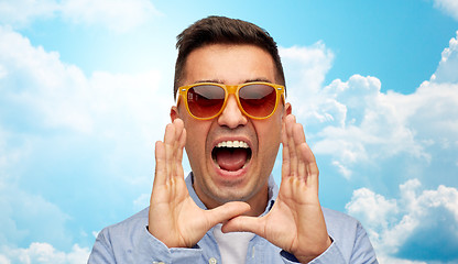 Image showing face of angry shouting man in shirt and sunglasses