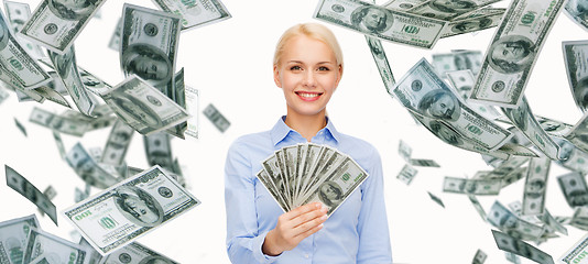 Image showing smiling businesswoman with dollar cash money