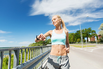 Image showing smiling young woman running outdoors