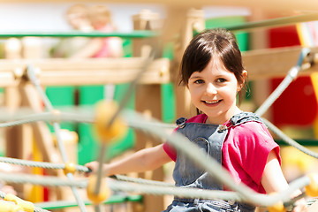 Image showing happy little girl climbing on children playground