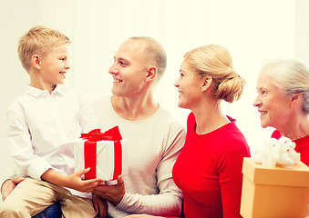 Image showing smiling family with gifts at home