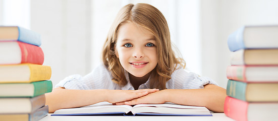 Image showing smiling little student girl with many books